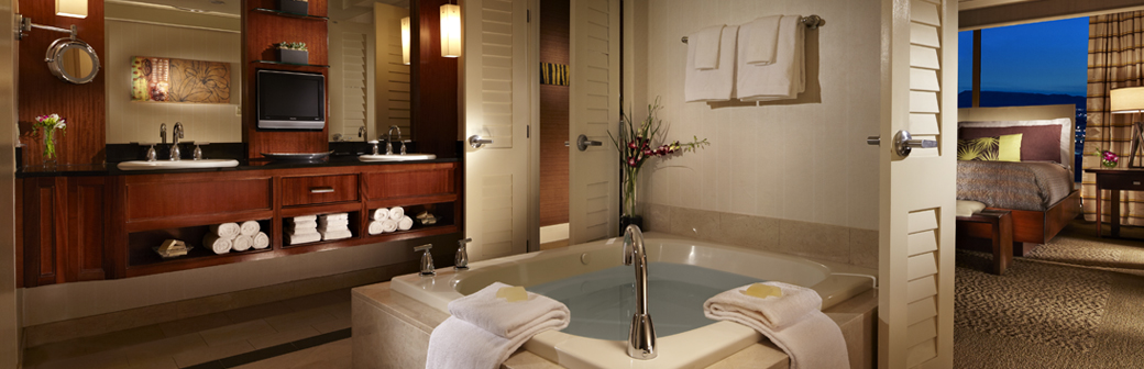 A bathroom with a jacuzzi tub and two sinks.